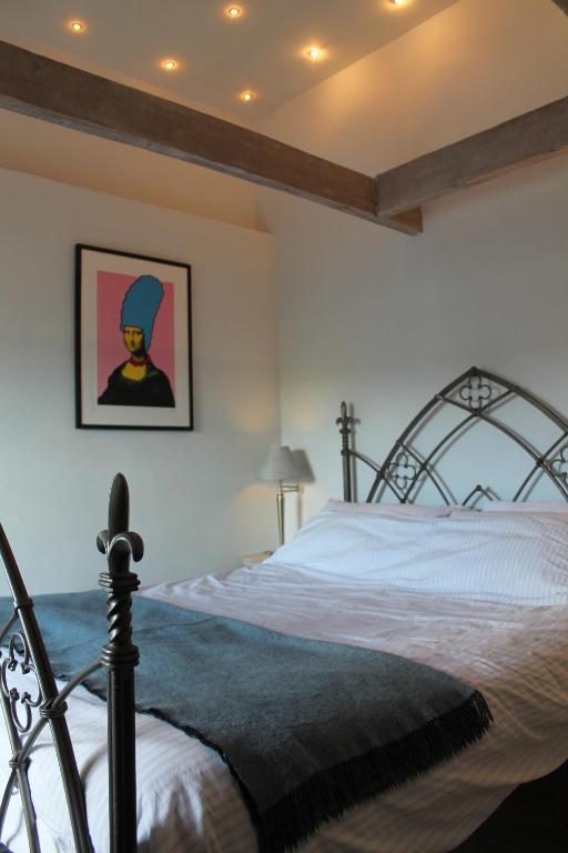 a bedroom with a bed with a metal frame at Sky Cottage in Fowey