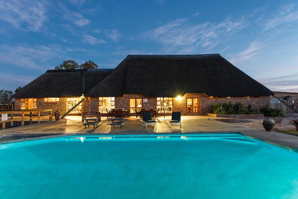 a resort with a swimming pool in front of a building at A-1 Njalo-NjaloSafari´s in Touwsrivier