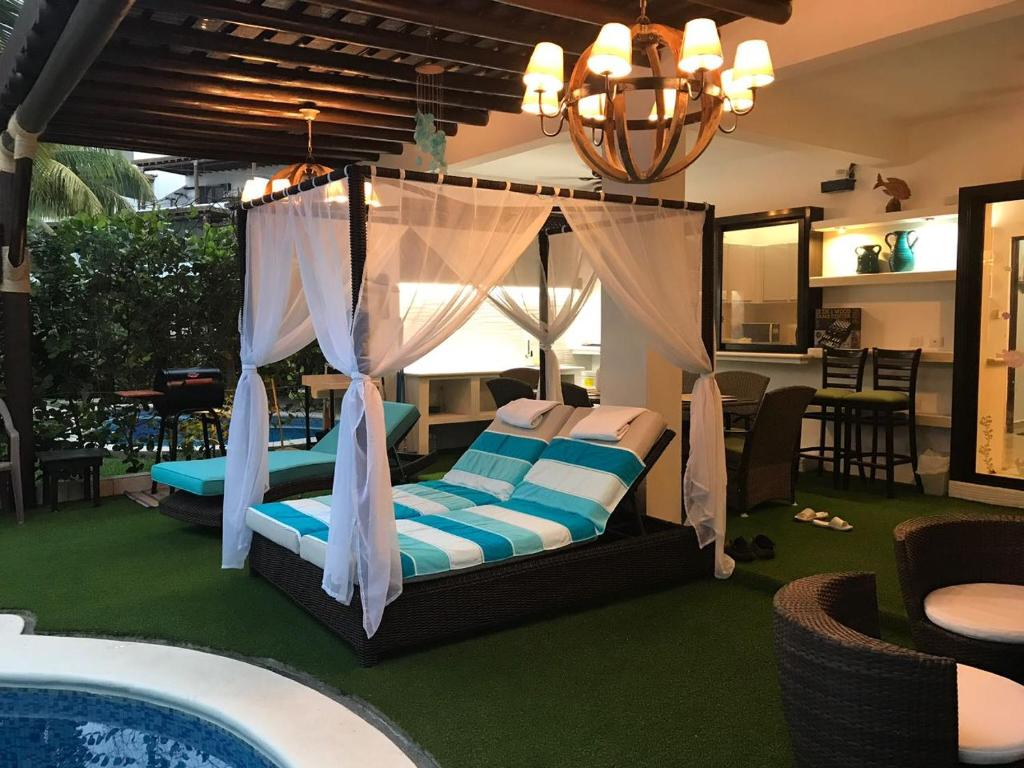 a bedroom with a canopy bed next to a pool at Villas Aqua Los Cabos in Monterrico