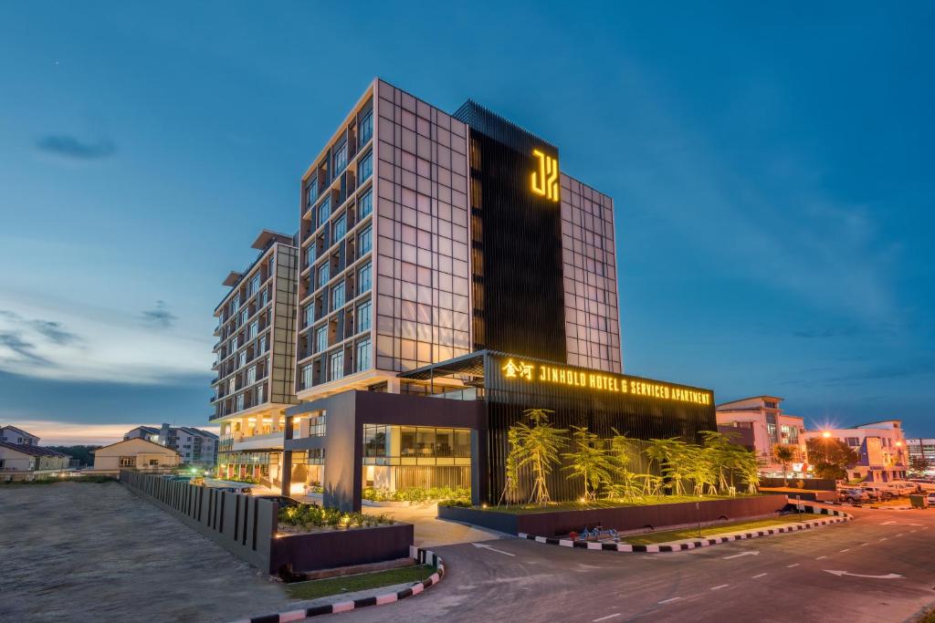 a tall building with a lot of windows at Jinhold Hotel & Serviced Apartment in Miri