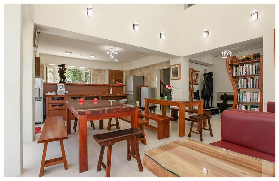 a living room with a table and chairs and a kitchen at Lu Home Art in Taitung City