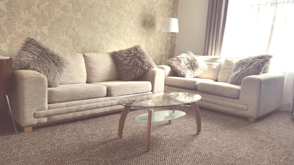 a living room with a couch and a table at Dumfries Central apartment in Dumfries