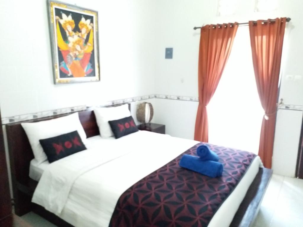 Postel nebo postele na pokoji v ubytování Jepun Segara Guest House