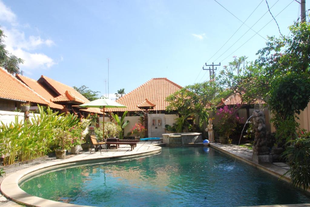 a swimming pool in the middle of a house at Wikarmas Villa Sanur in Sanur