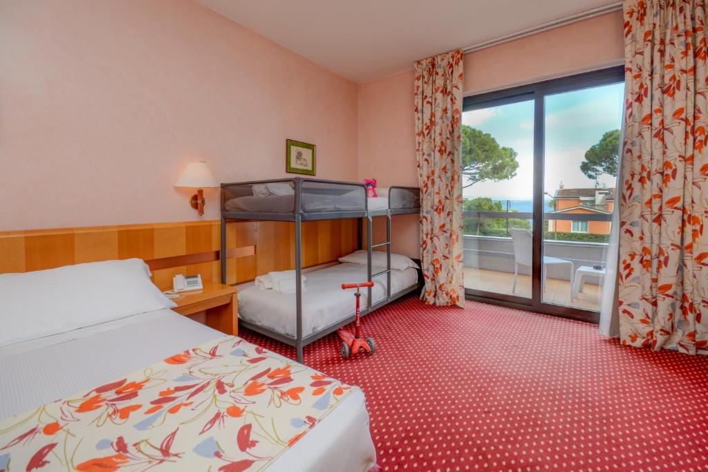 Postel nebo postele na pokoji v ubytování Hotel Oliveto