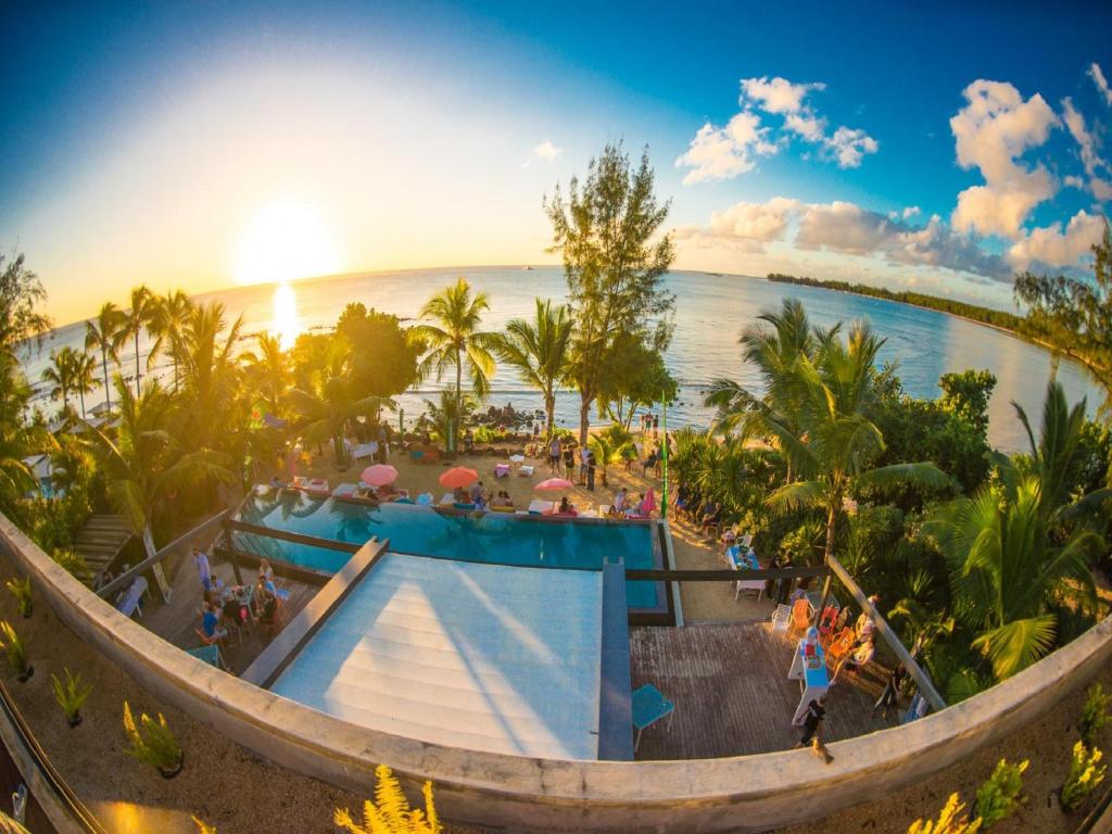 an aerial view of a resort with a pool and the ocean at Mystik Life Style by NEWMARK in Mont Choisy