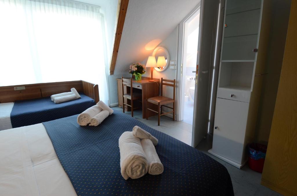 Postel nebo postele na pokoji v ubytování Hotel Mimosa
