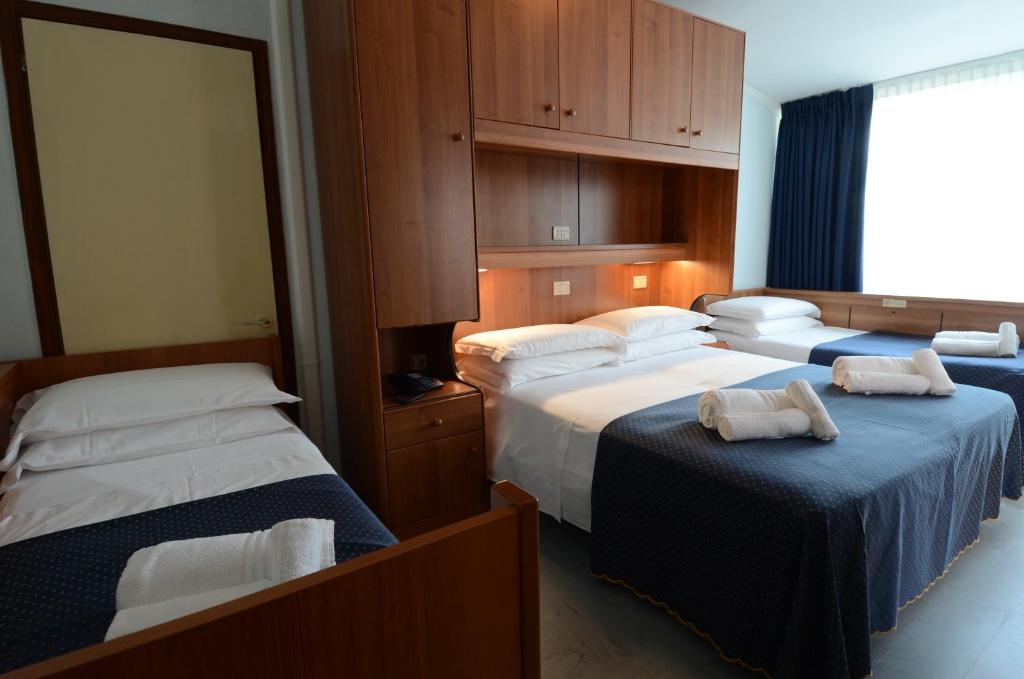 Postel nebo postele na pokoji v ubytování Hotel Mimosa