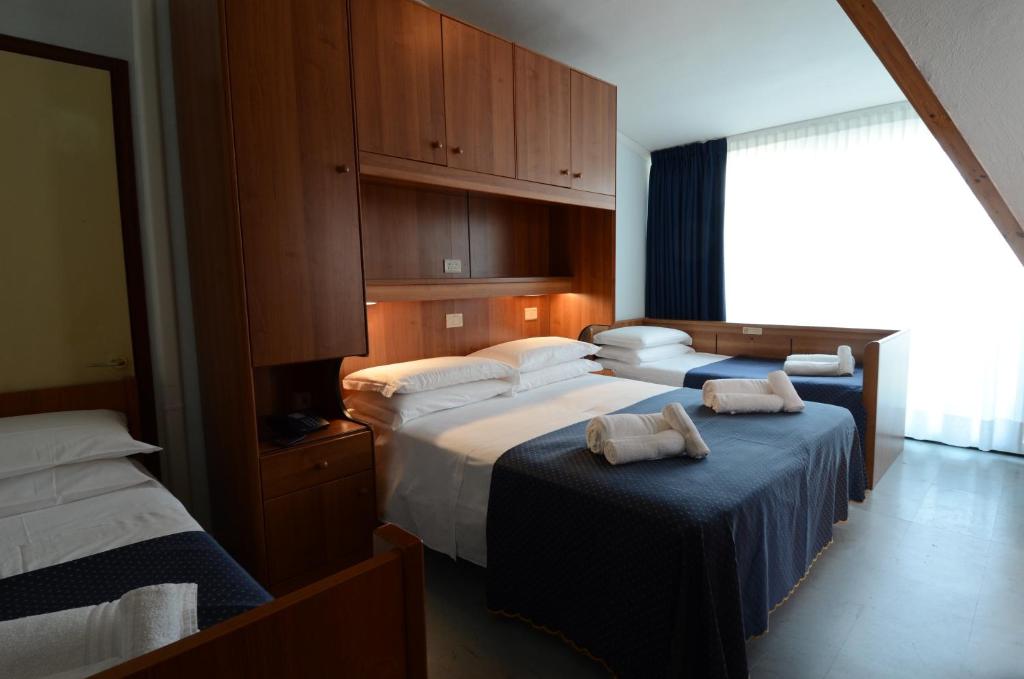 Postel nebo postele na pokoji v ubytování Hotel Mimosa