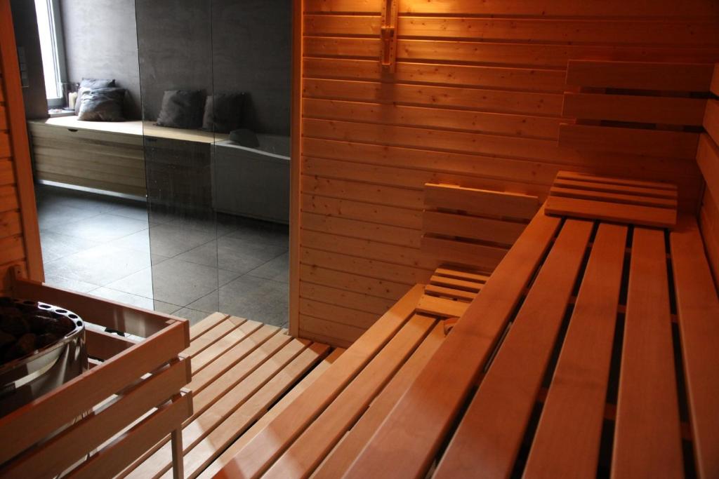 a sauna with two wooden benches in a room at Blue House Relax in Velké Popovice