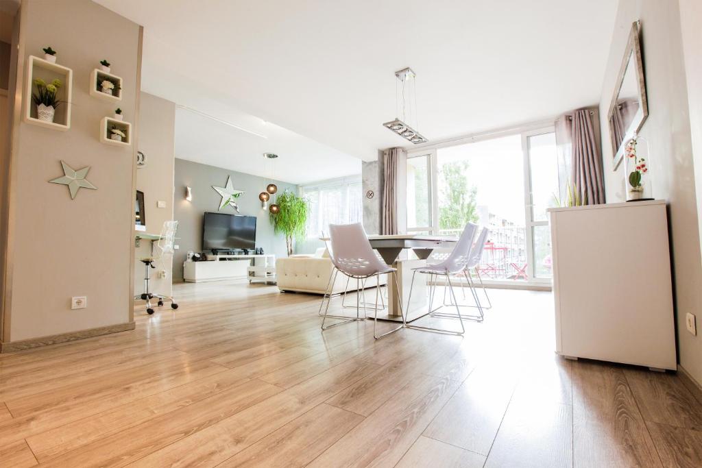 a kitchen and living room with a table and chairs at Le Célestay in Villeurbanne