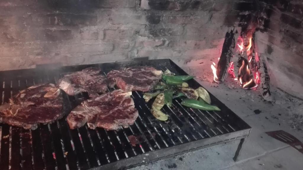 a group of meat and vegetables cooking on a grill at Guesthouse Porec in Poreč