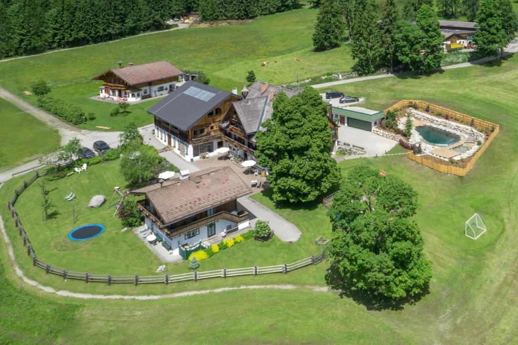 an aerial view of a large house on a field at Ramsbergerhof in Ramsau am Dachstein