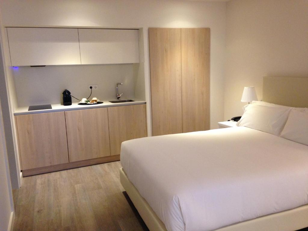 Postel nebo postele na pokoji v ubytování San Lorenzo Suites