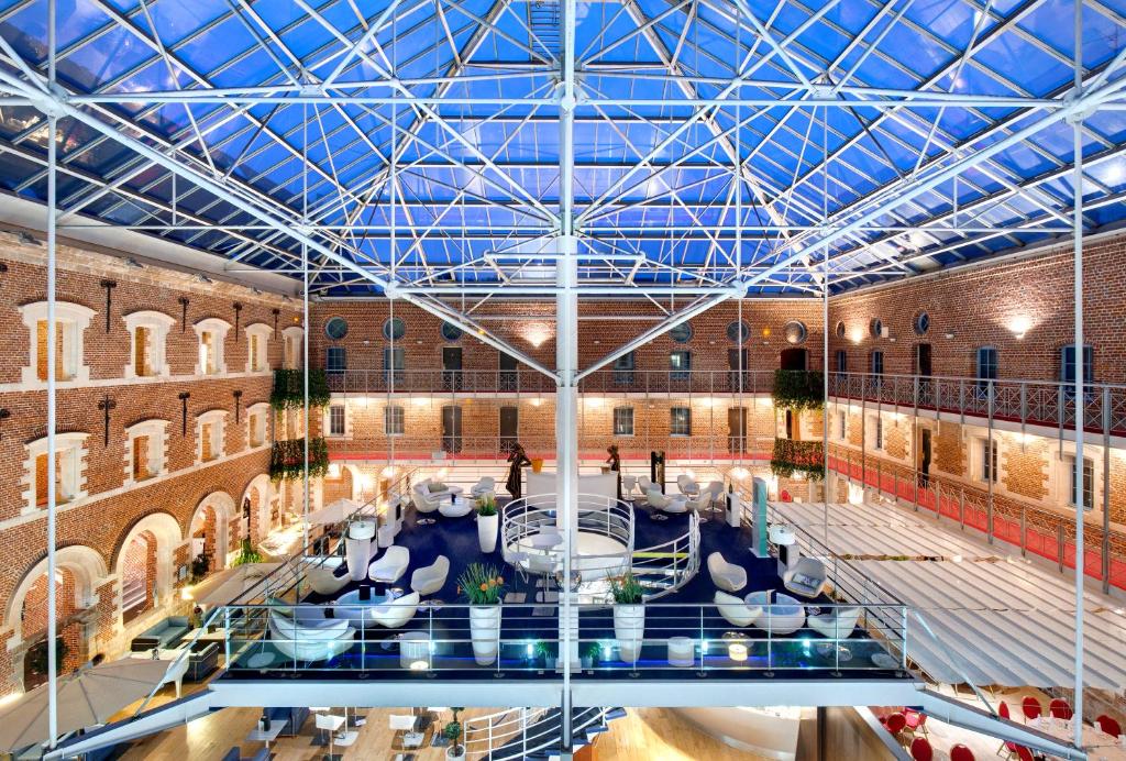 a large building with a glass ceiling and a pool at Alliance Lille - Couvent Des Minimes in Lille