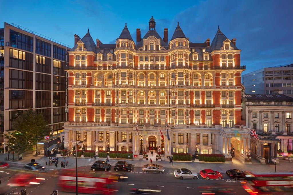 a lit up building with cars in front of it at Mandarin Oriental Hyde Park, London in London
