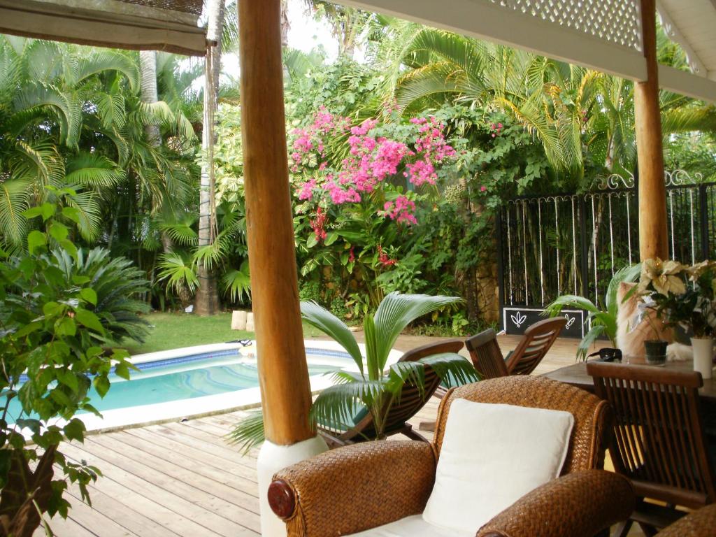 a patio with a table and chairs and a pool at Casa Blanca in Las Terrenas