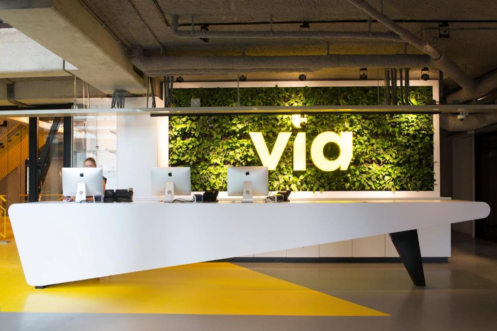 a white table with a vio sign on a wall at Via Amsterdam in Amsterdam