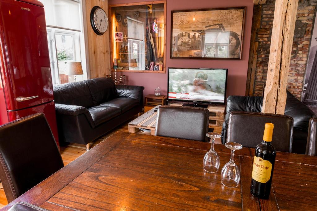 a living room with a table with wine bottles on it at Tangs in Ísafjörður
