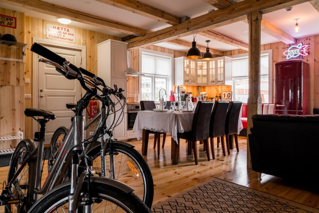 a bike parked in a room with a dining room at Tangs in Ísafjörður