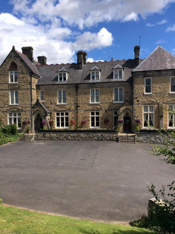 an old stone house with a large driveway at The Mount B&B in Malton