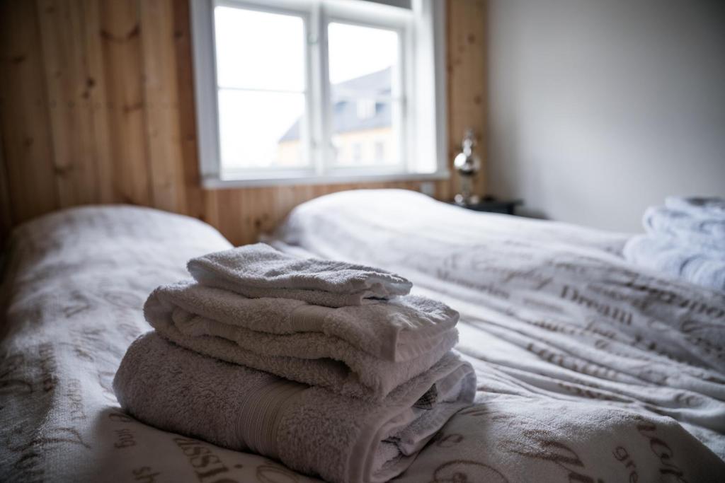 a pile of towels sitting on top of a bed at Tangs in Ísafjörður