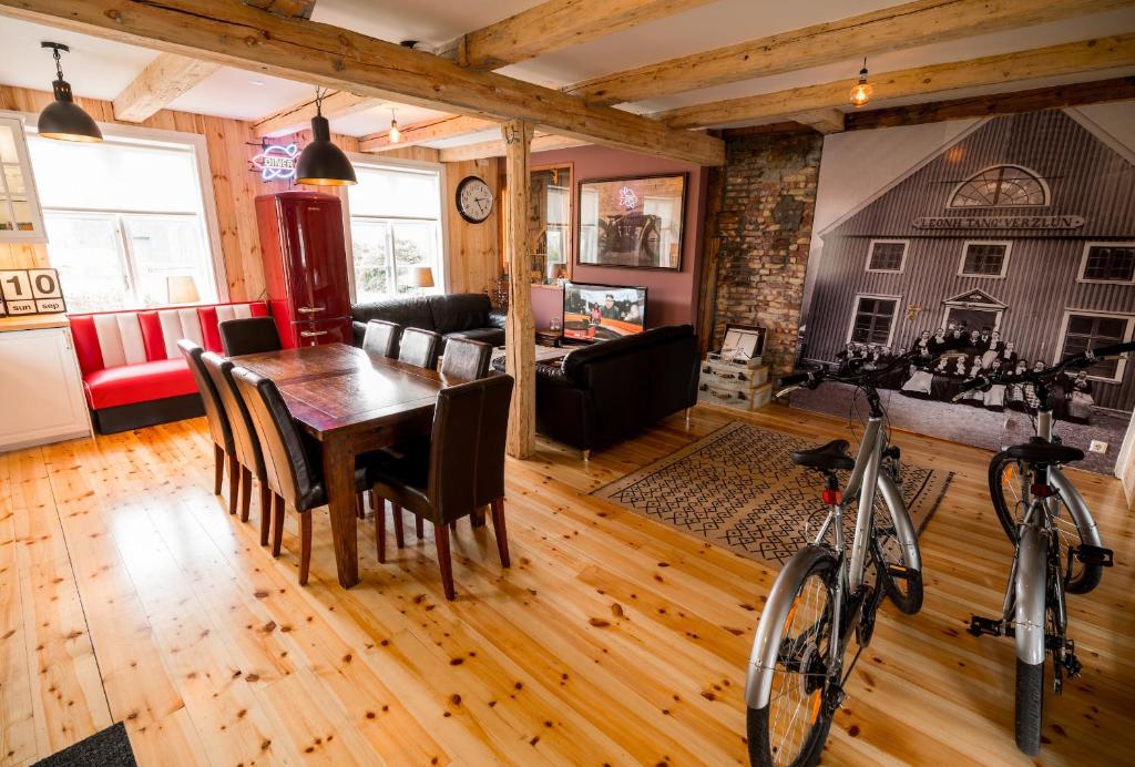 a dining room and living room with a table and a bike at Tangs in Ísafjörður