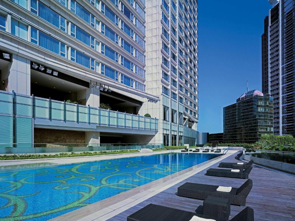 a swimming pool in the middle of a building at Hyatt Regency Hong Kong Tsim Sha Tsui in Hong Kong
