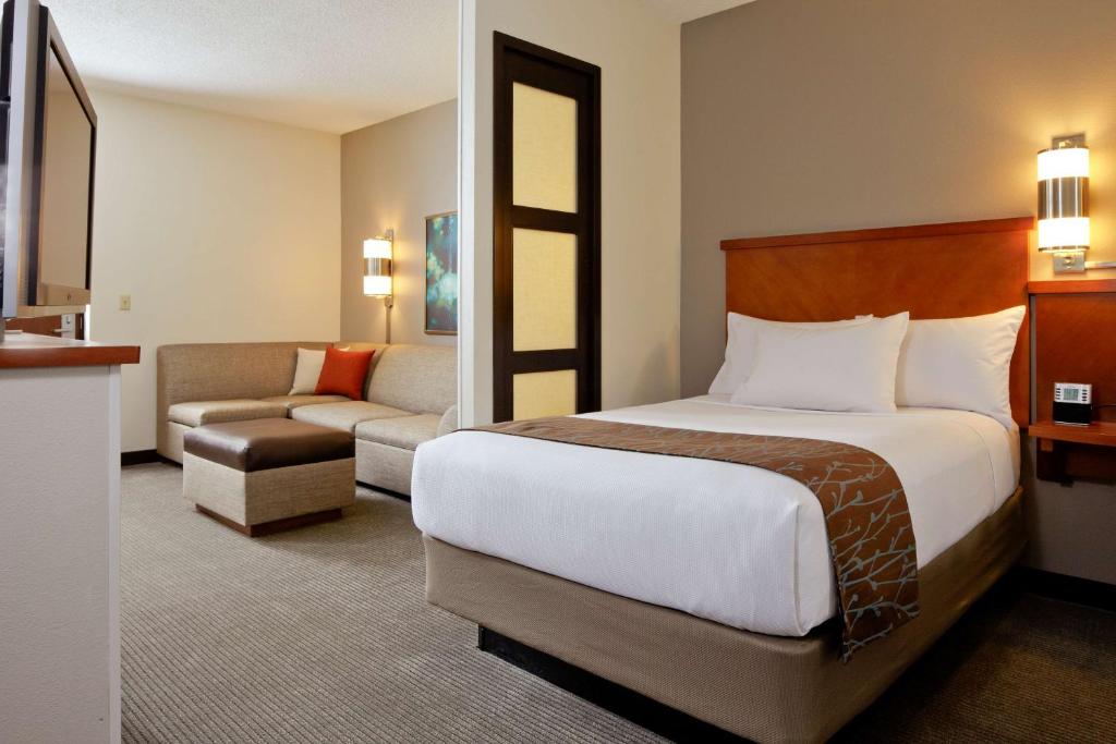 a hotel room with a bed and a couch at Hyatt Place Scottsdale/Old Town in Scottsdale