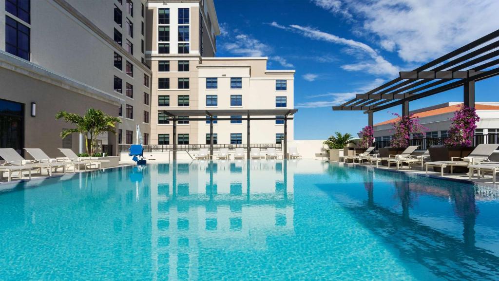 a large swimming pool in front of a building at Hyatt Place Boca Raton in Boca Raton