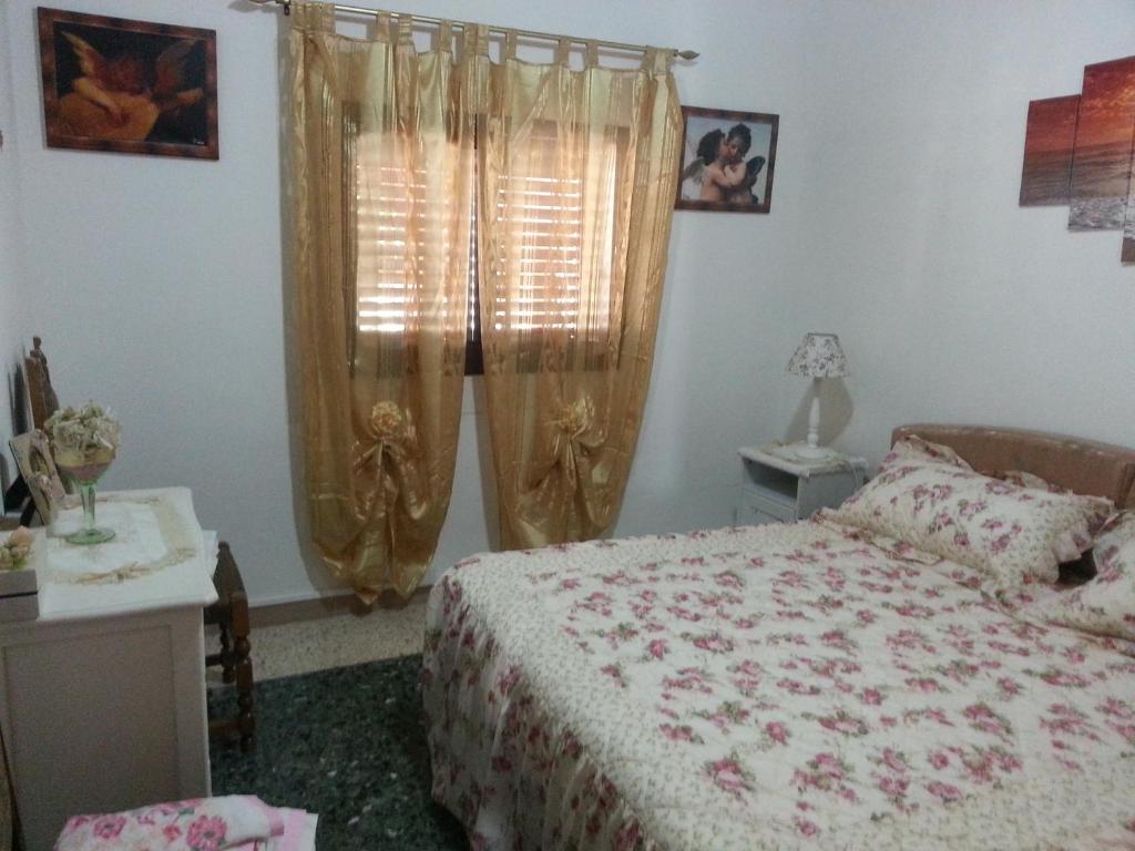 A bed or beds in a room at Casa di Lory Bruca