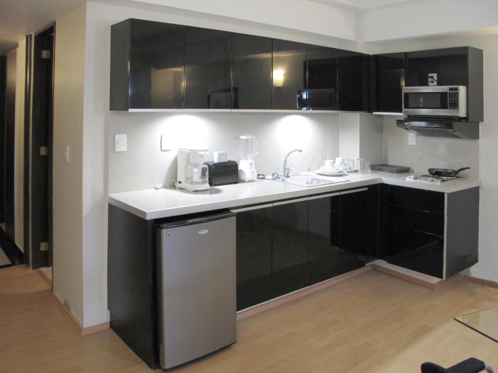 A compact black-and-white kitchenette fitted into the apartment living area.