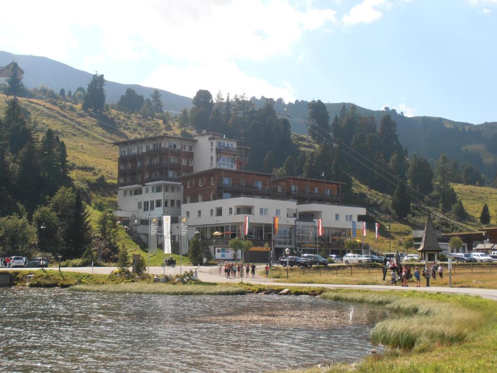 um grande edifício ao lado de uma massa de água em Sundance Mountain Resort em Turracher Höhe