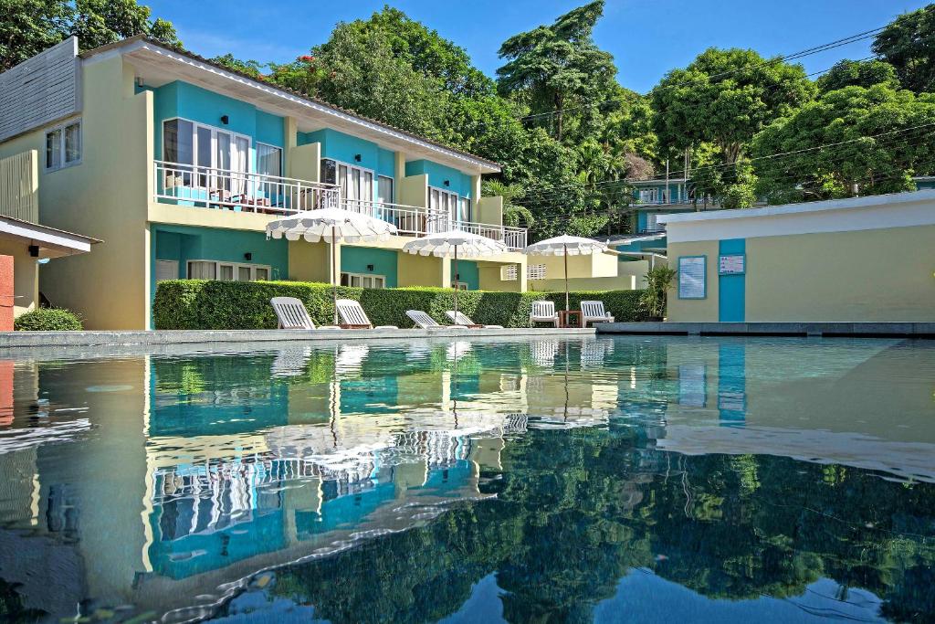 a swimming pool in front of a building at Aqua Beads Samed in Ko Samed