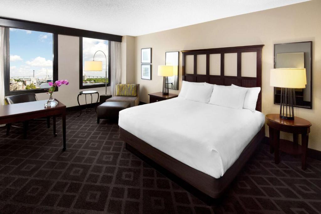 a hotel room with two beds and a desk at Hyatt Regency Savannah in Savannah