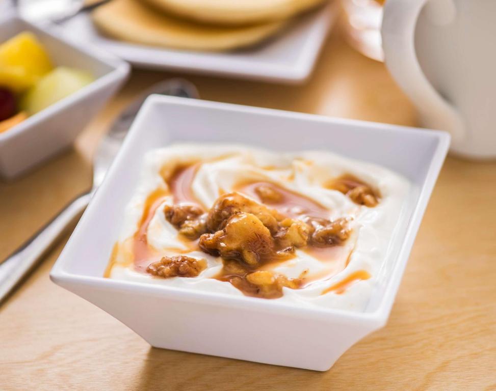 a white bowl of food with nuts on a table at Hyatt Place Austin Airport in Austin