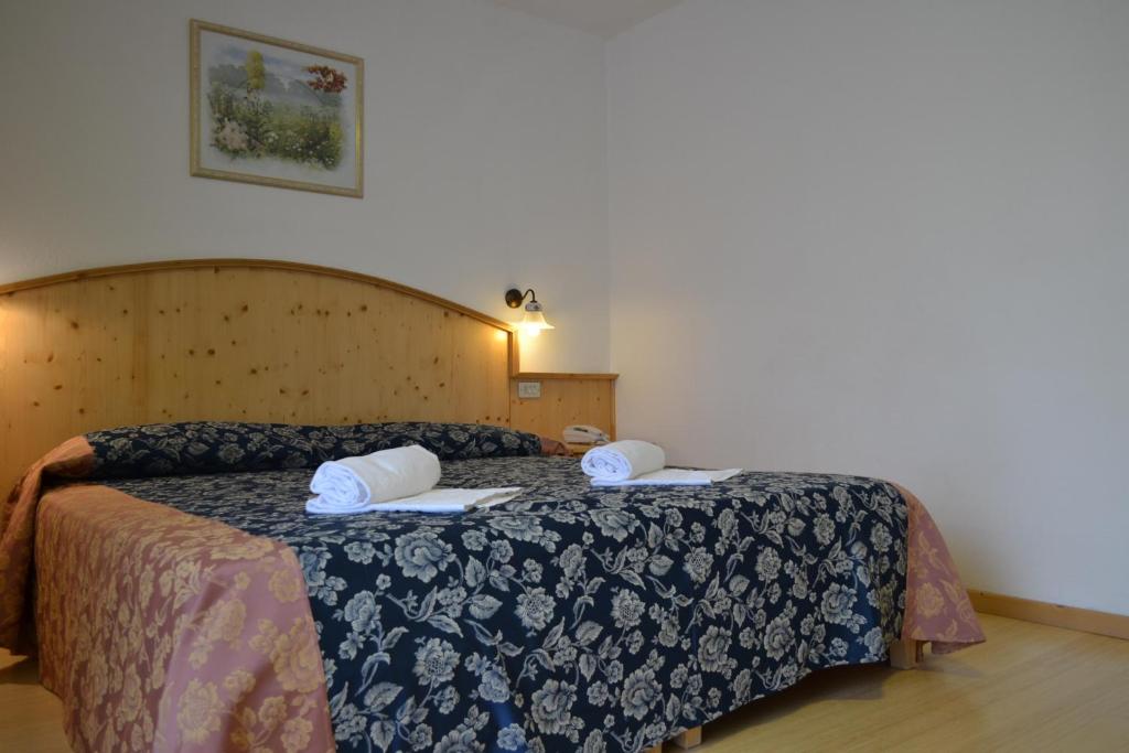 Postel nebo postele na pokoji v ubytování Hotel Corona