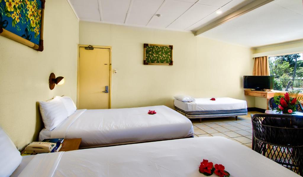 Rúm í herbergi á Tanoa Skylodge Hotel