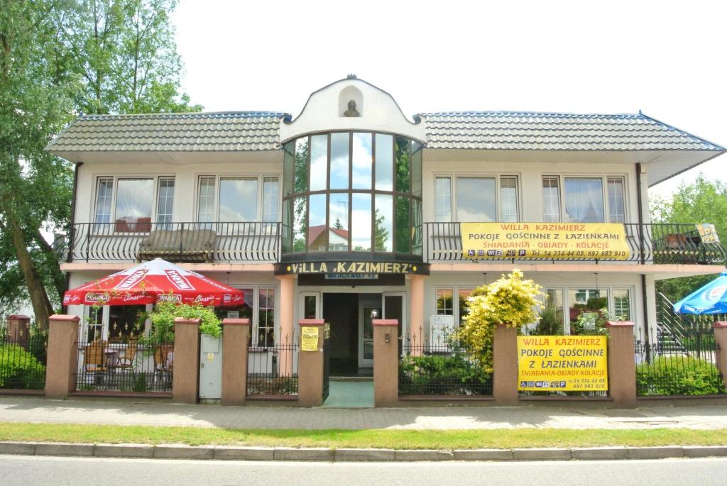 a large building with a sign in front of it at Willa Kazimierz in Ciechocinek