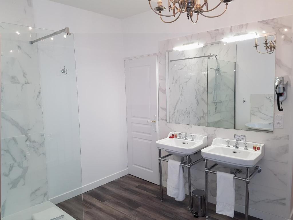 a white bathroom with two sinks and a shower at Le Tardif, Noble Guesthouse in Bayeux