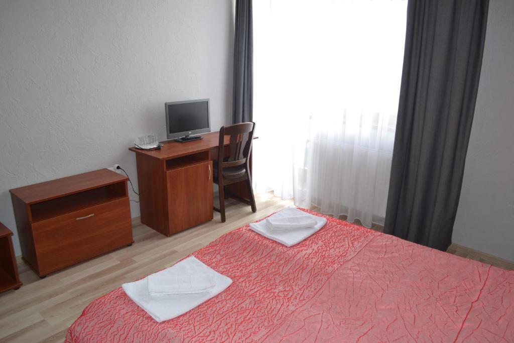 Postel nebo postele na pokoji v ubytování Hotel Helikon