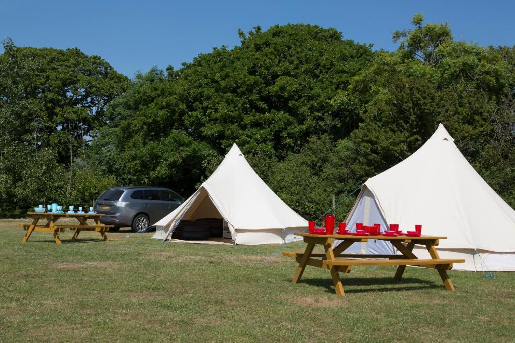 a group of tents and picnic tables in a field at Herston Caravan & Camping in Swanage