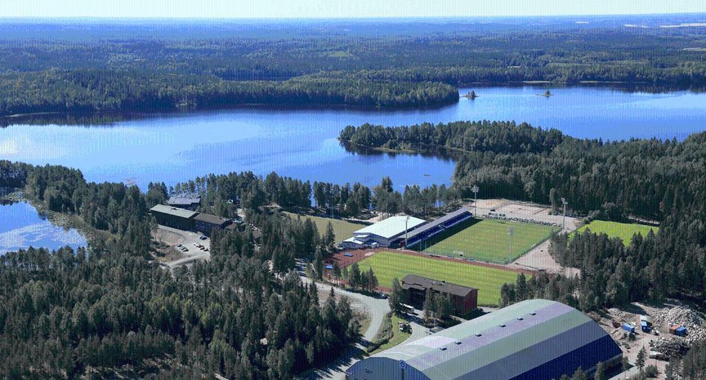 an aerial view of a building next to a lake at Eerikkilä Sport & Outdoor Resort in Tammela