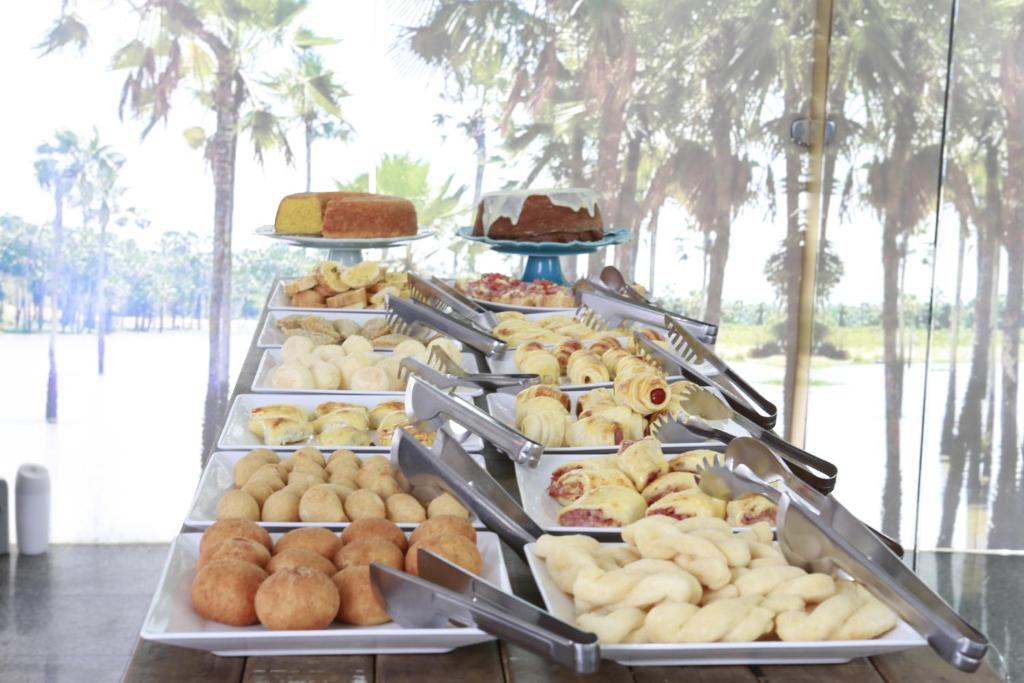 a display case filled with different types of pastries at Uchôa Teresina Hotel in Teresina
