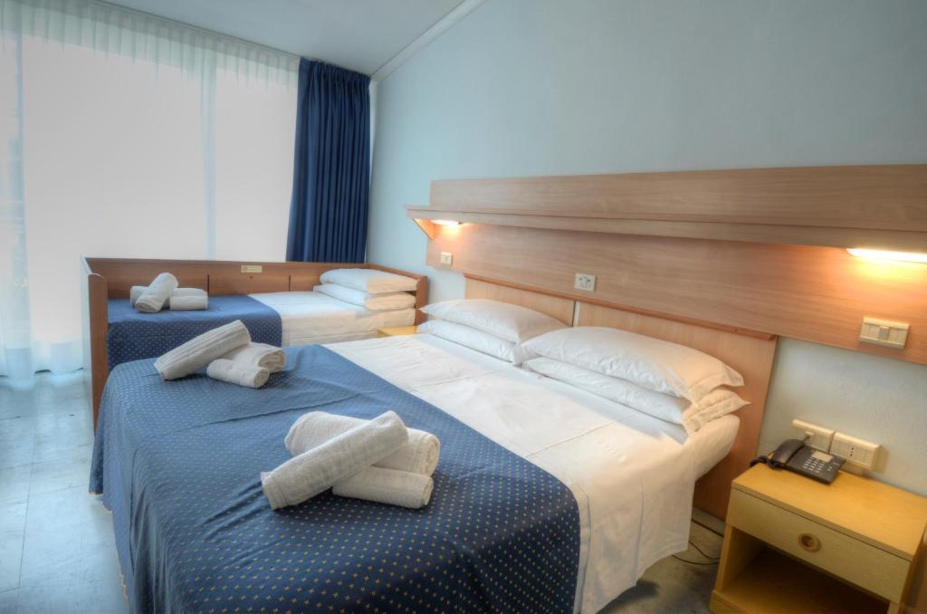 Postel nebo postele na pokoji v ubytování Hotel Mimosa
