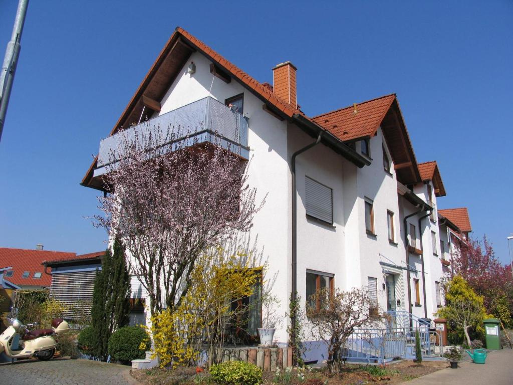 een wit huis met een rood dak bij Ferienwohnung Bei Franka mit Sauna in Freiburg im Breisgau