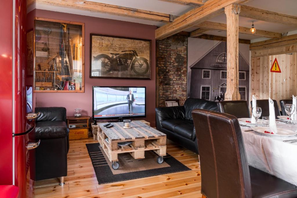 a living room with a couch and a tv at Tangs in Ísafjörður