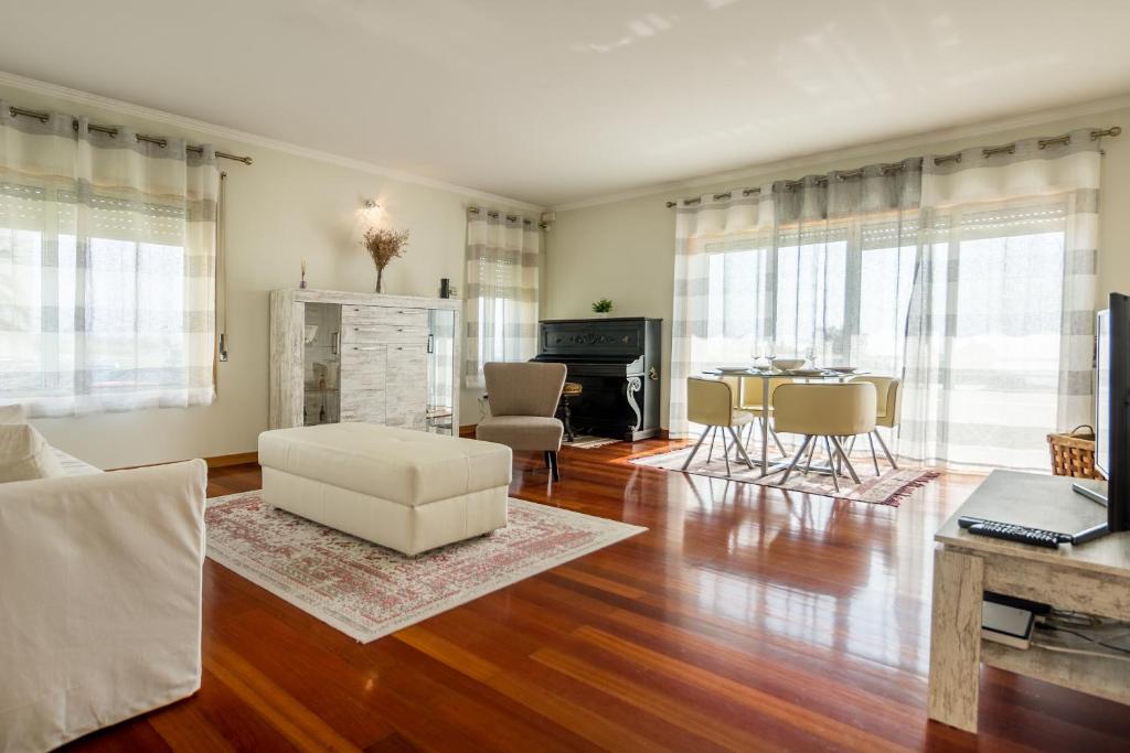 a living room with a couch and a table at São Félix Ocean Views Apartment in São Félix da Marinha