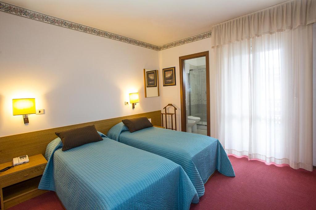 Postel nebo postele na pokoji v ubytování Hotel Lido