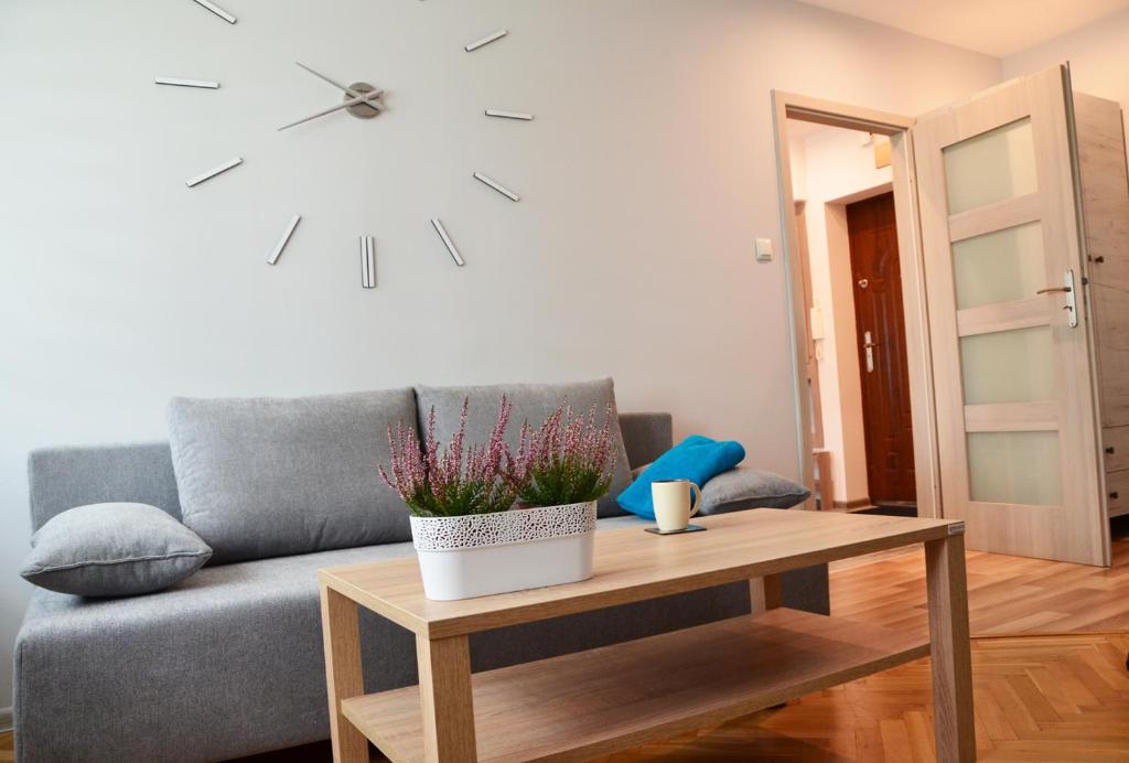 - un salon avec un canapé et une table dans l'établissement Apartament Leliwa - Centrum, à Tarnów